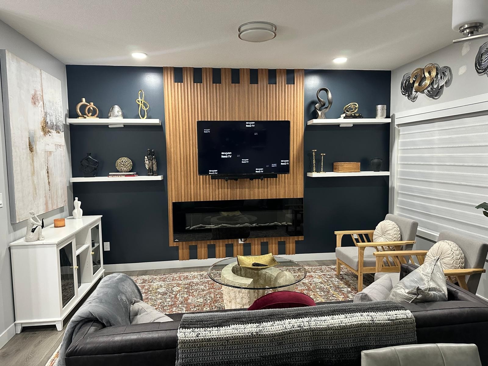 Wide view of navy media wall and full lounge seating
