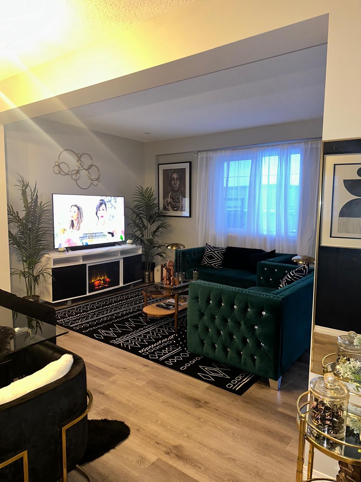Emerald sofas with white marble TV console and electric fireplace
