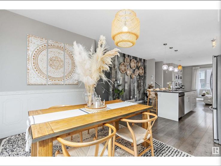 Wider dining view with white mandala art and woven pendant