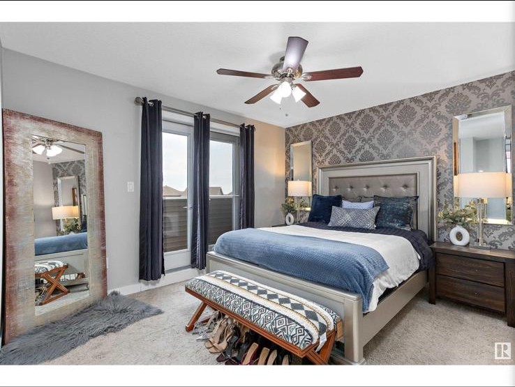 Primary bedroom with leaning mirror and blue bedding