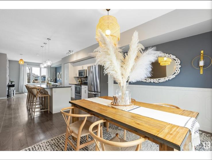 Dining table with pampas grass centerpiece and wishbone chairs
