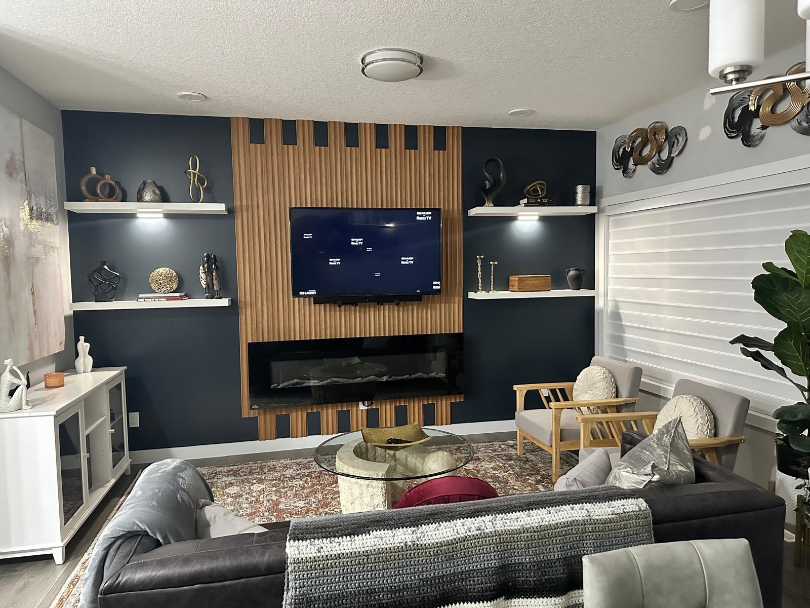 Linear fireplace built into the navy slat feature wall
